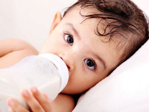 A baby drinking from a bottle.