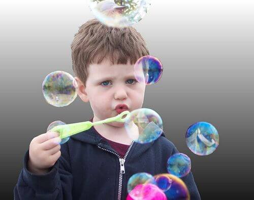 Un enfant qui fait des bulles.