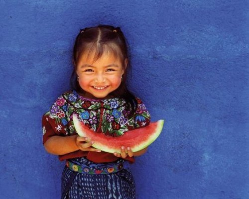 A young girl eating watermelon.