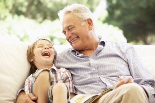A child laughing with his grandfather.