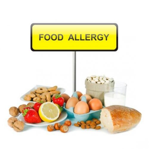 Allergy food concept - bread, milk, fruits, nuts, eggs and beans on white background