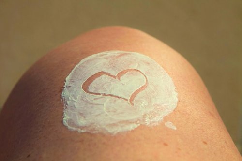 Lotion on a woman's leg with a heart drawn in it.