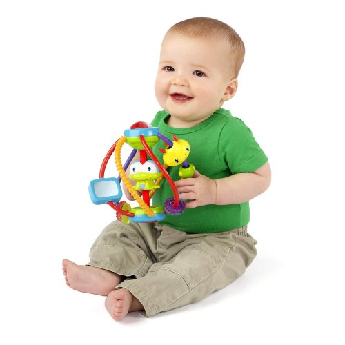 A baby holding an educational toy.