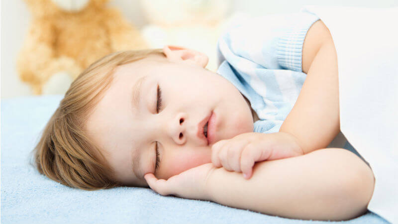Nino durmiendo con camiseta azul