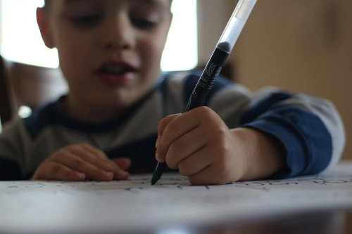 A child writing in a notebook.