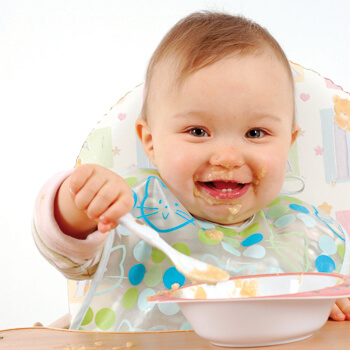 A baby eating homemade food.