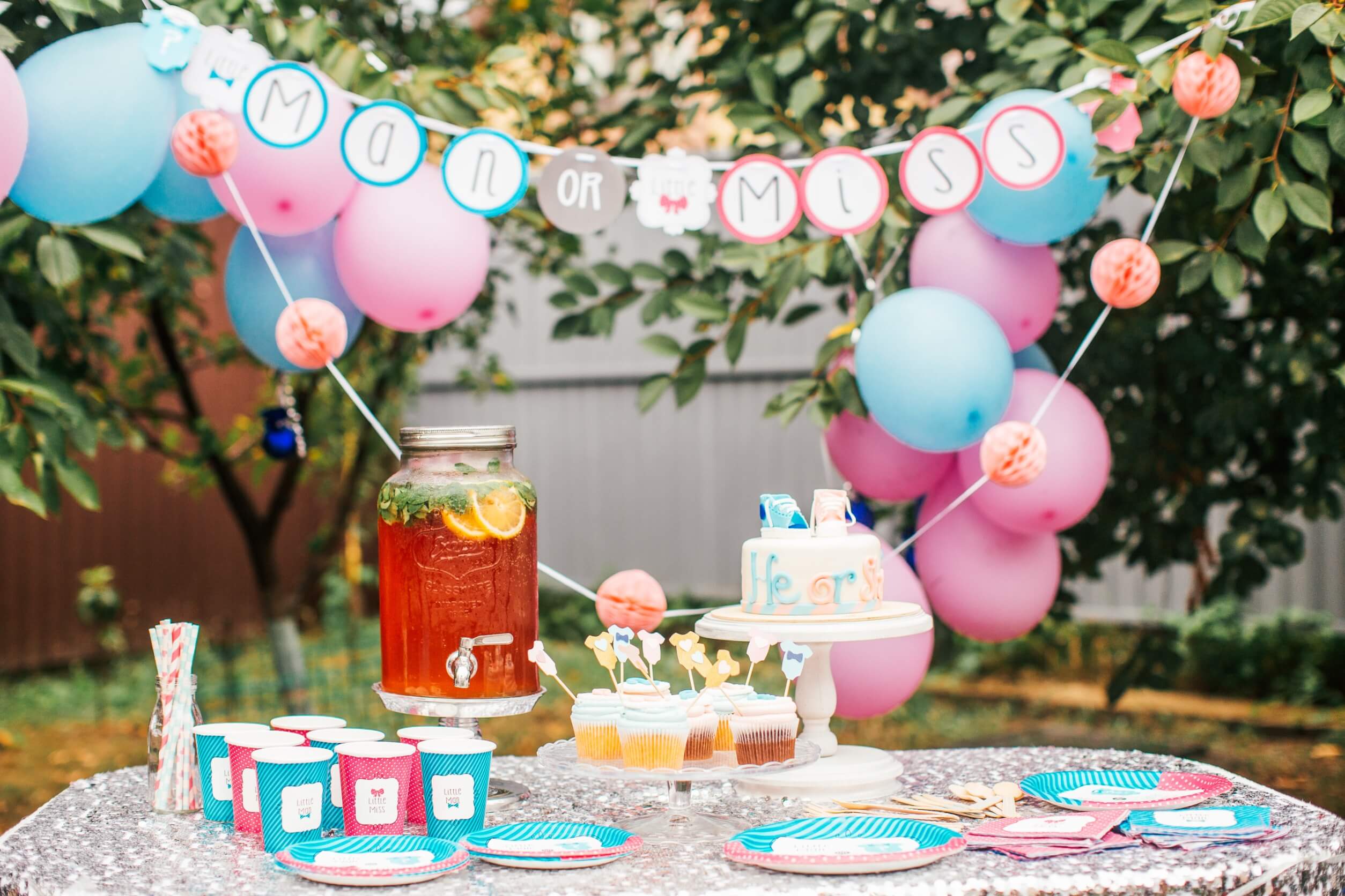 A table with tea and cupcakes to make a gender announcement.