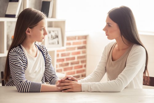 A mother having a serious conversation with her teen daughter.