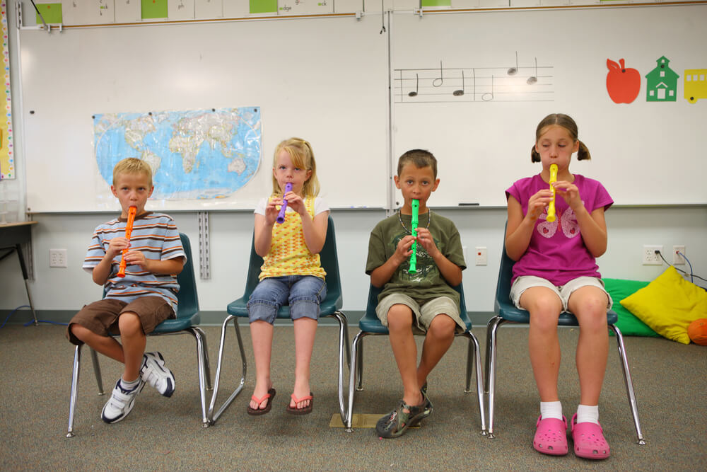Elementary students playing the recorder.
