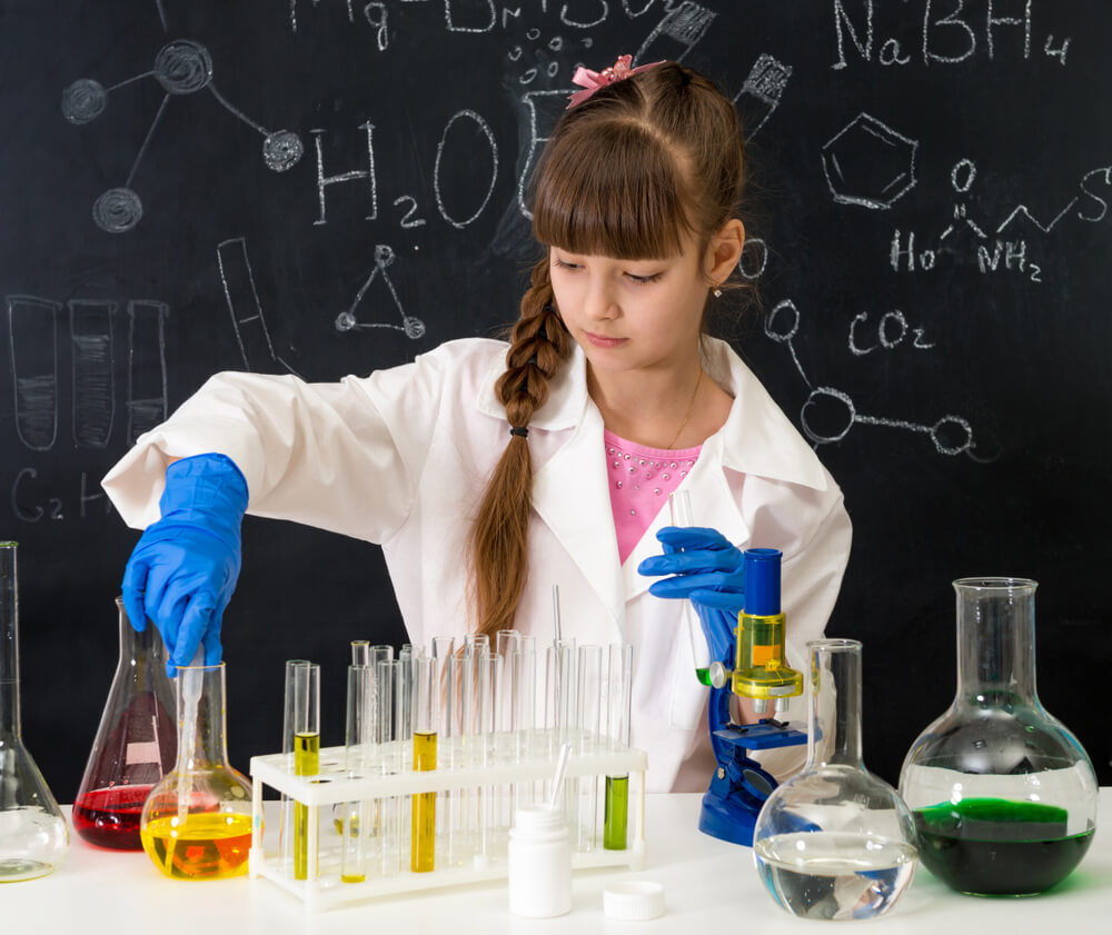A young girl performing scientific experiments.