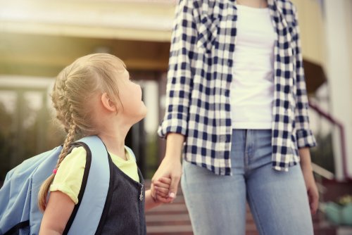 Madre acompañando a su hija los primeros días de colegio.