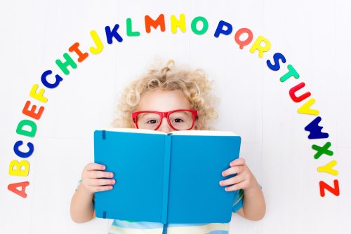 Niño con un libro infantil para aprender las letras en las manos.