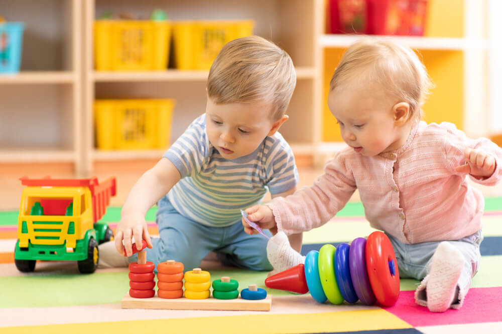 Babies playing with toys at daycare.