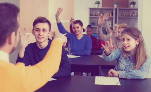 Profesor animando a sus alumnos a preguntar para mejorar en clase.