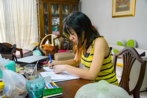 Chica estudiando en el salón como uno de sus hábitos de estudio.