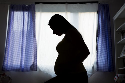 Mujer embarazada pensando en el parto fisiológico.