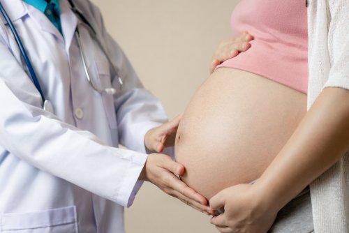Mujer embarazada siendo examinada por el doctor.