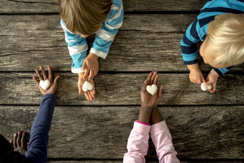 Niños con piedras en forma de corazón.