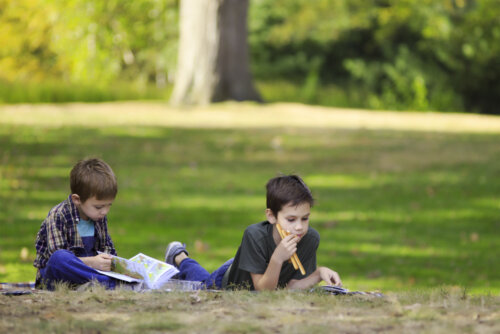 Niños leyendo libros infantiles para valorar la amistad en el parque.