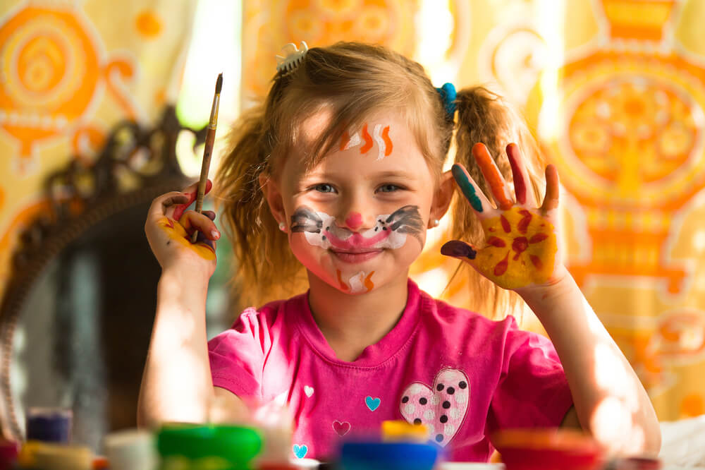 Niña con la cara pintada para expresar su talento creativo.