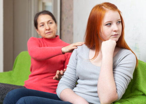 Madre intentando hablar con su hija adolescente para empezar la inoculación del estrés.