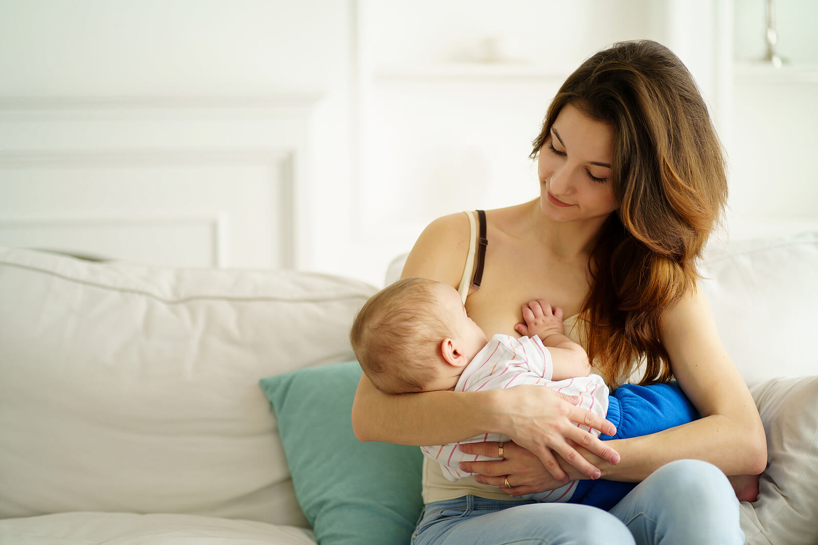 A mother breastfeeding her son.