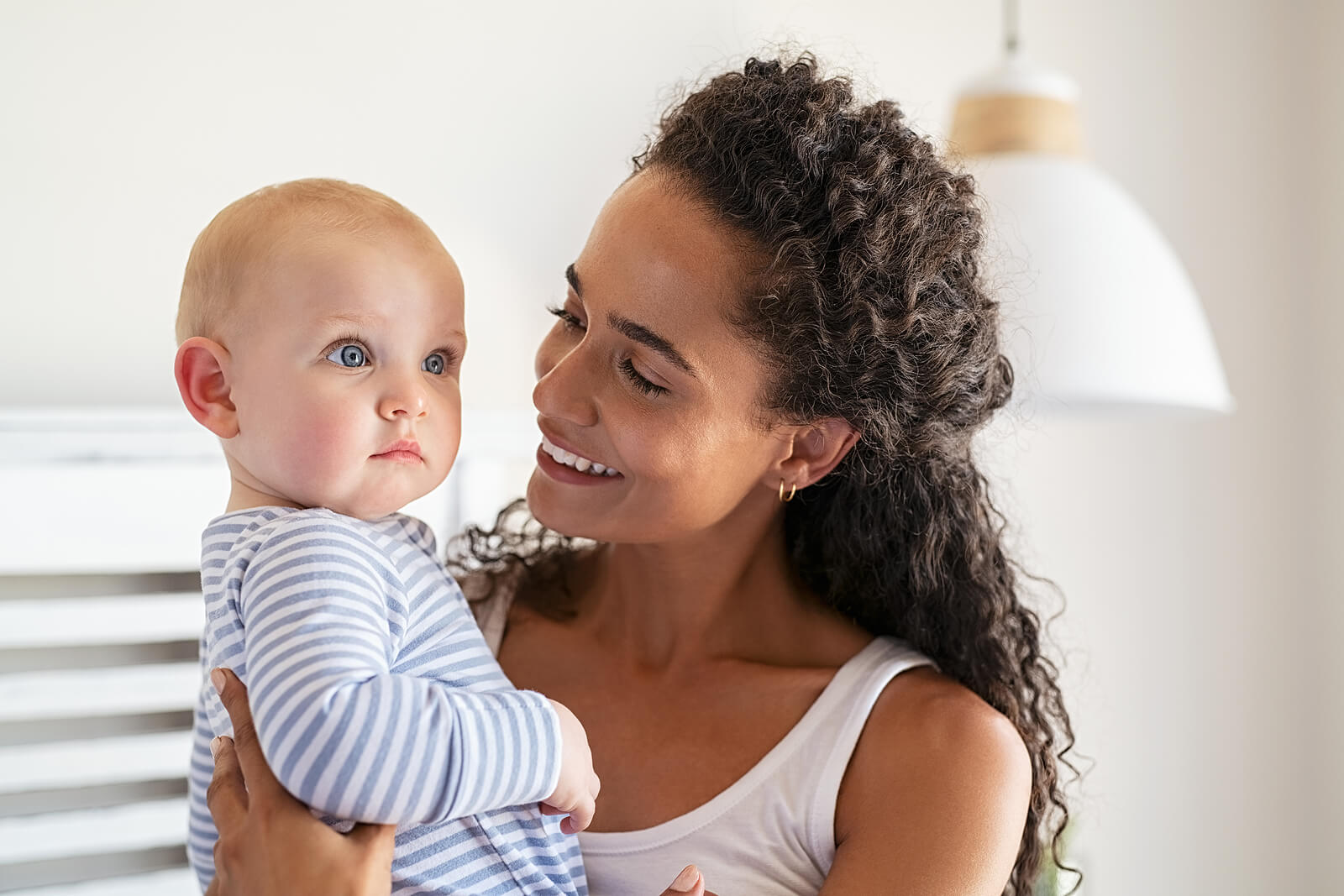 Mom with her baby smiling with happiness.