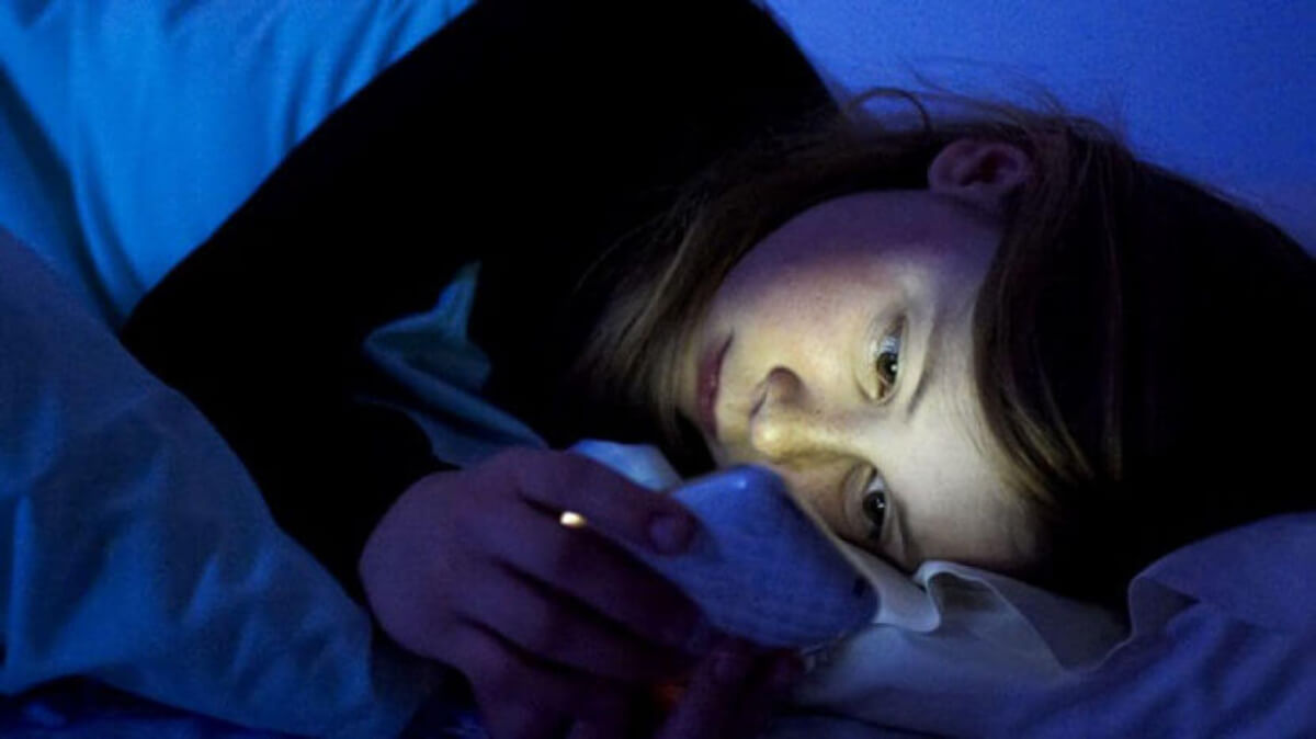 Fille regardant de la pornographie sur un mobile.