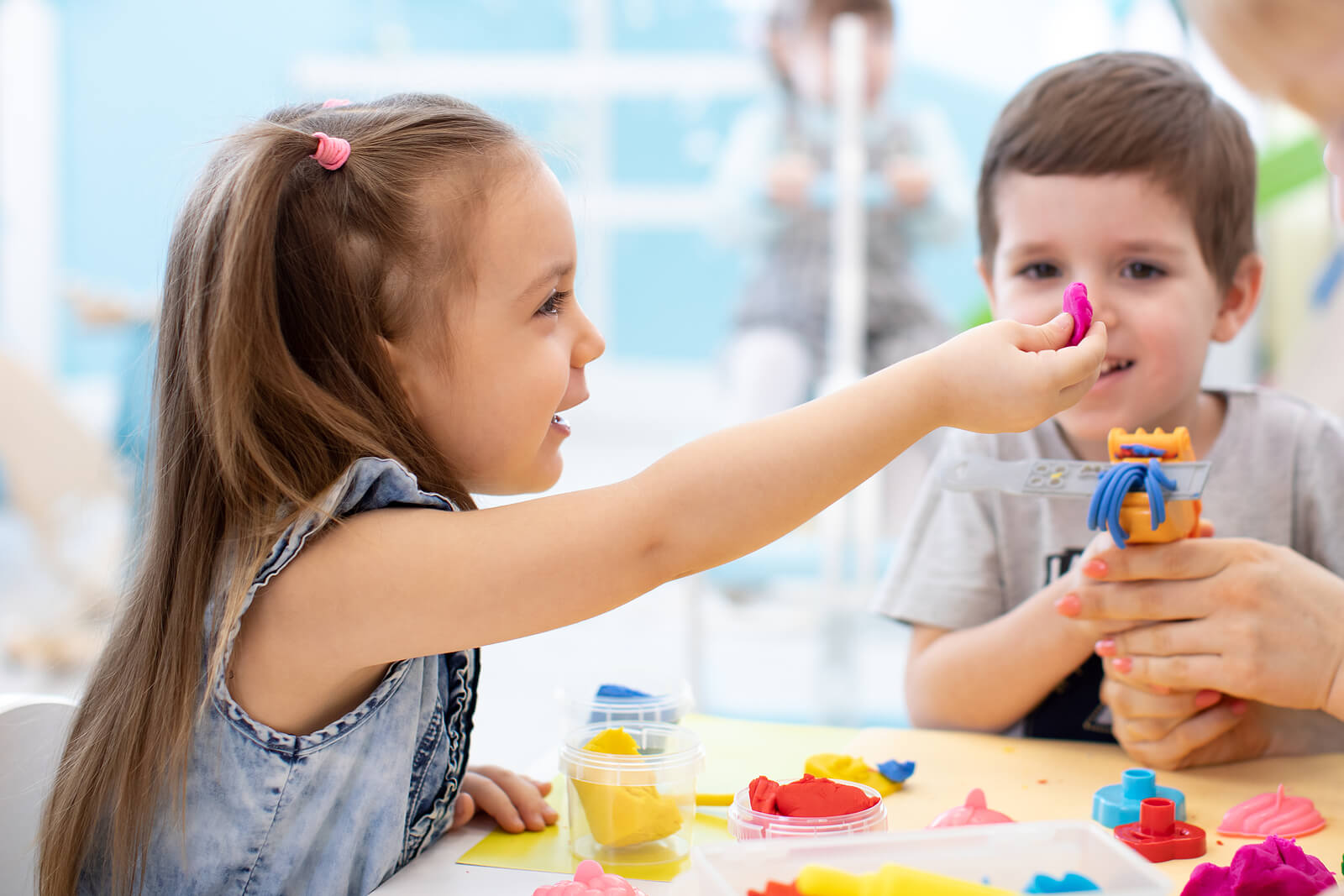 Niño jugando con plastilina haciendo actividades y manualidades sensoriales para niños agitados.