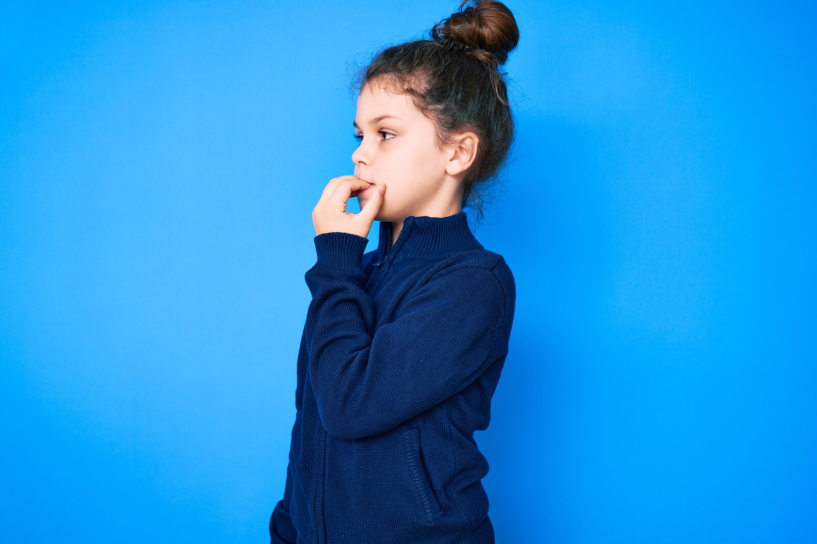 A girl biting her nails.