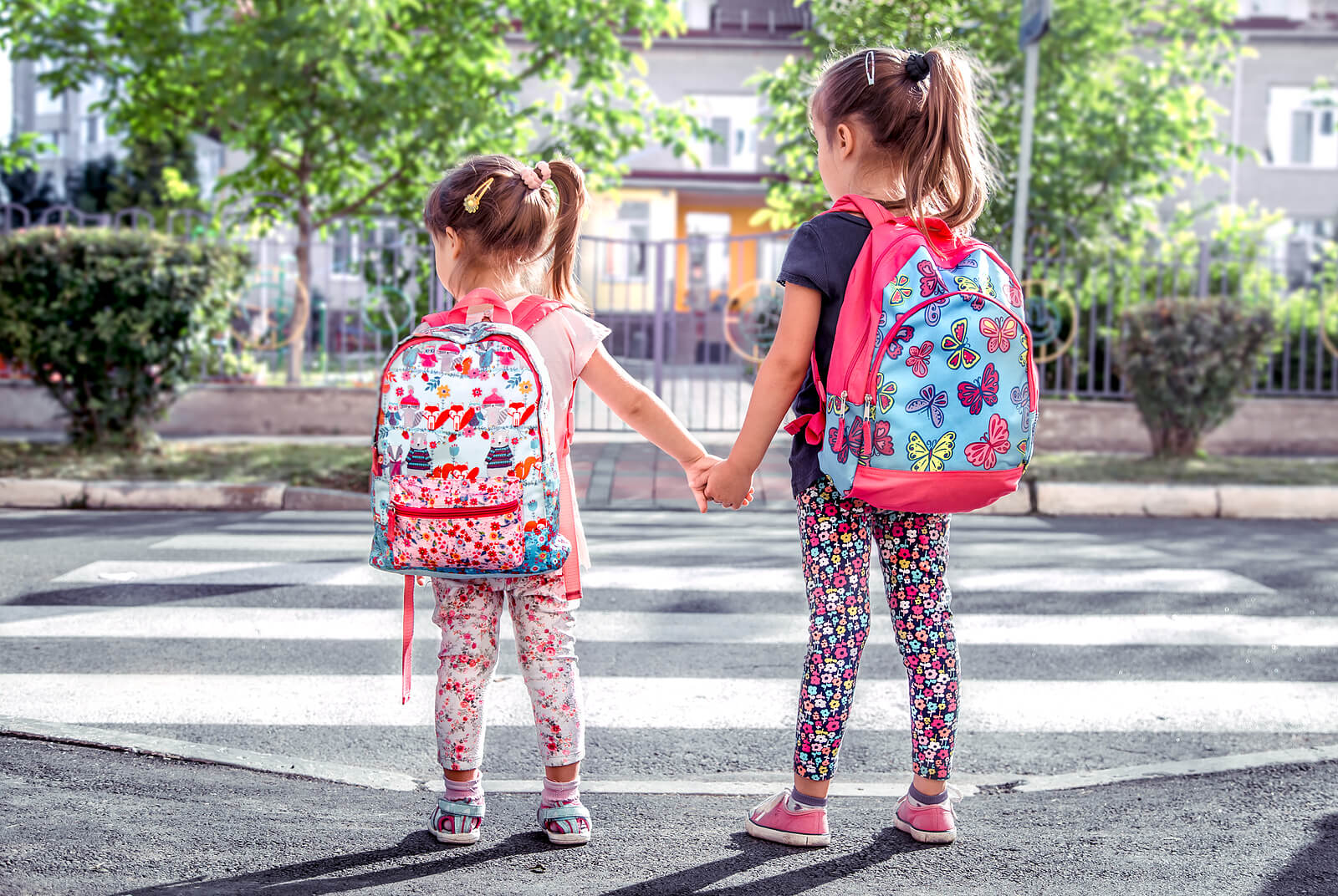 Girls going to school with their backpacks.