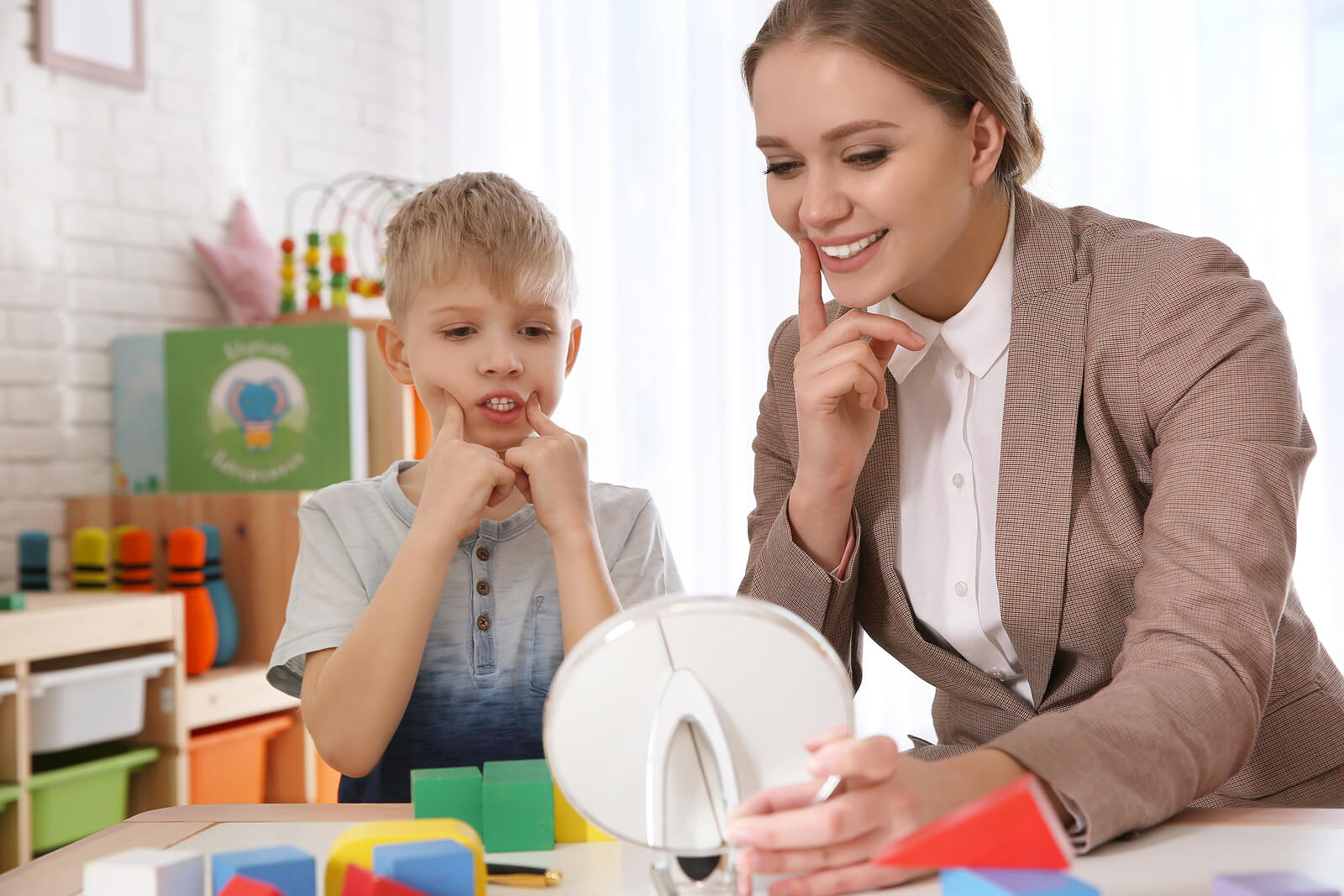 A speech therapist working with a child.