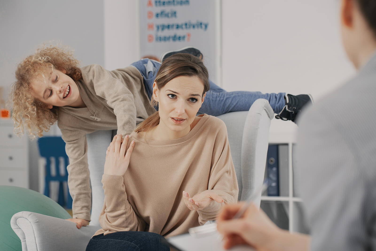 A boy with ADHD in therapy with his mother.