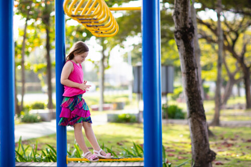 Niña jugando sola en el parque.