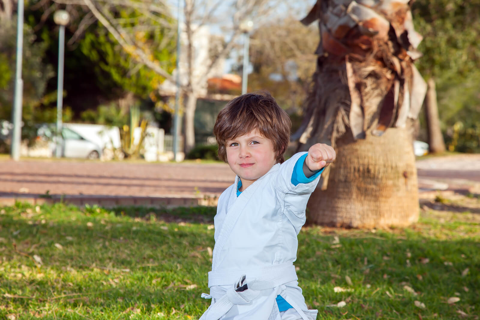 Un enfant qui pratique le judo en plein air.