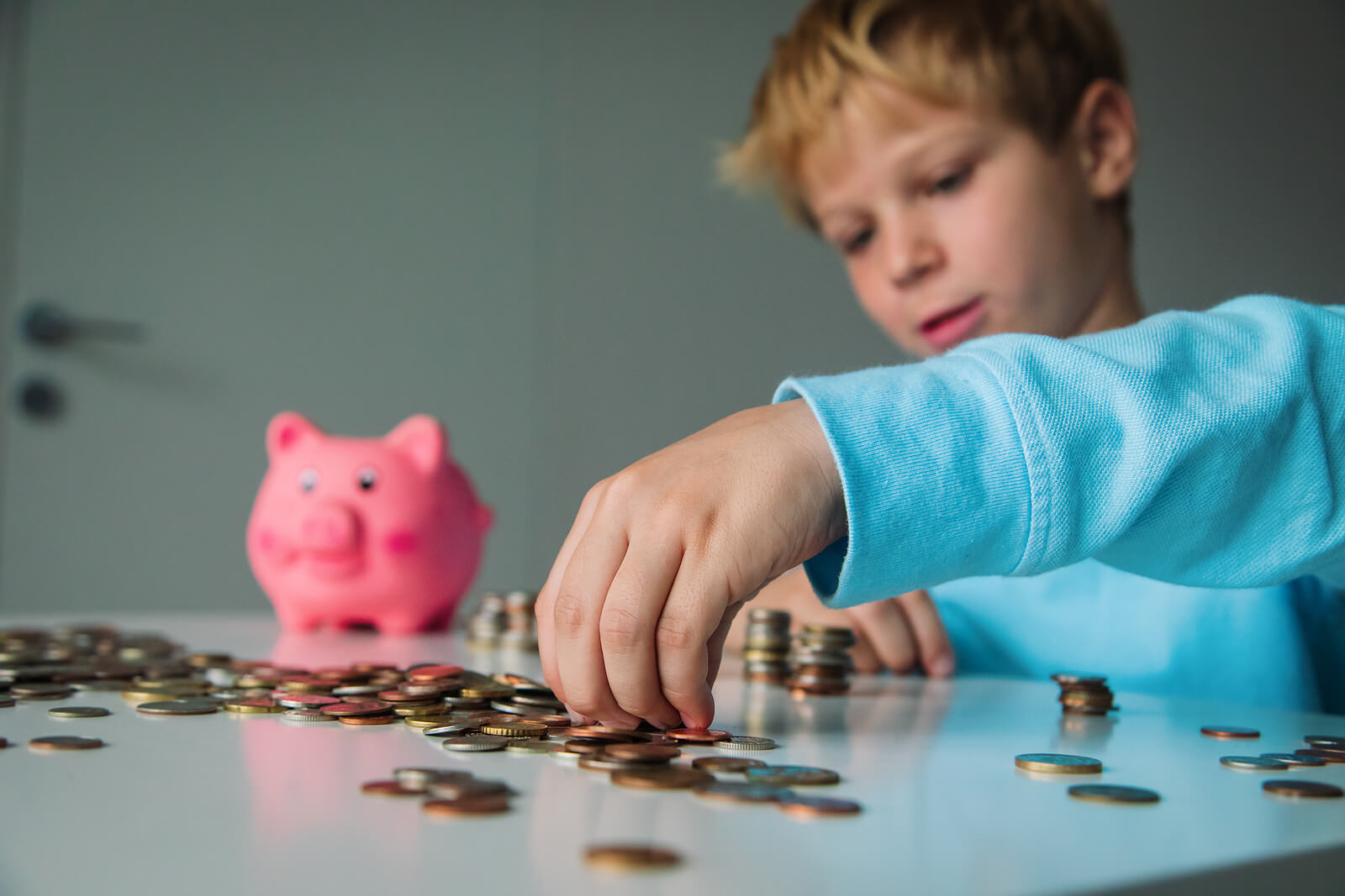 A child counting coins from his piggy bank.