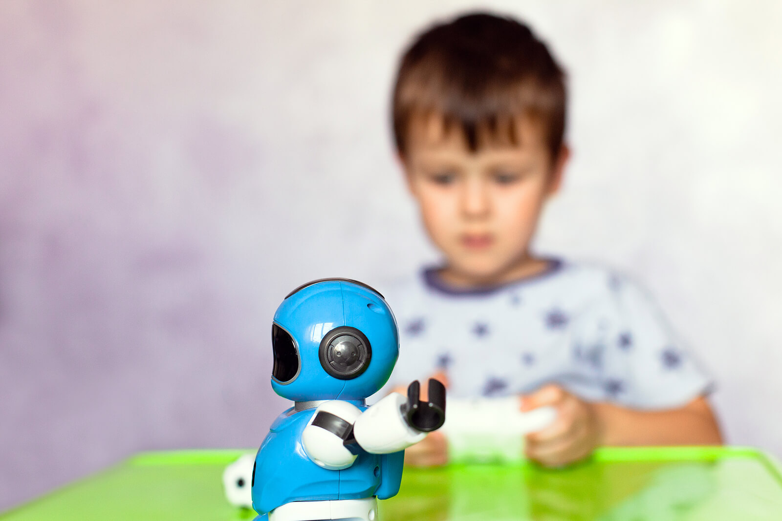 Niño jugando con un robot con inteligencia artificial.