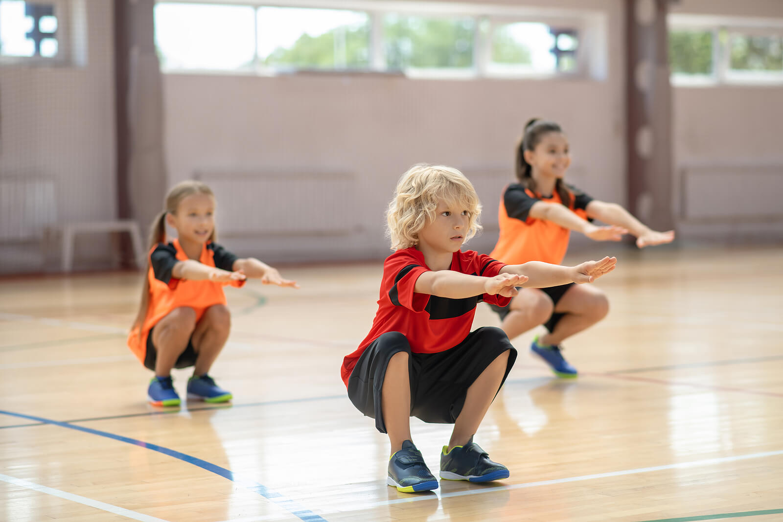 Niños haciendo sentadillas como parte del entrenamiento de resistencia.