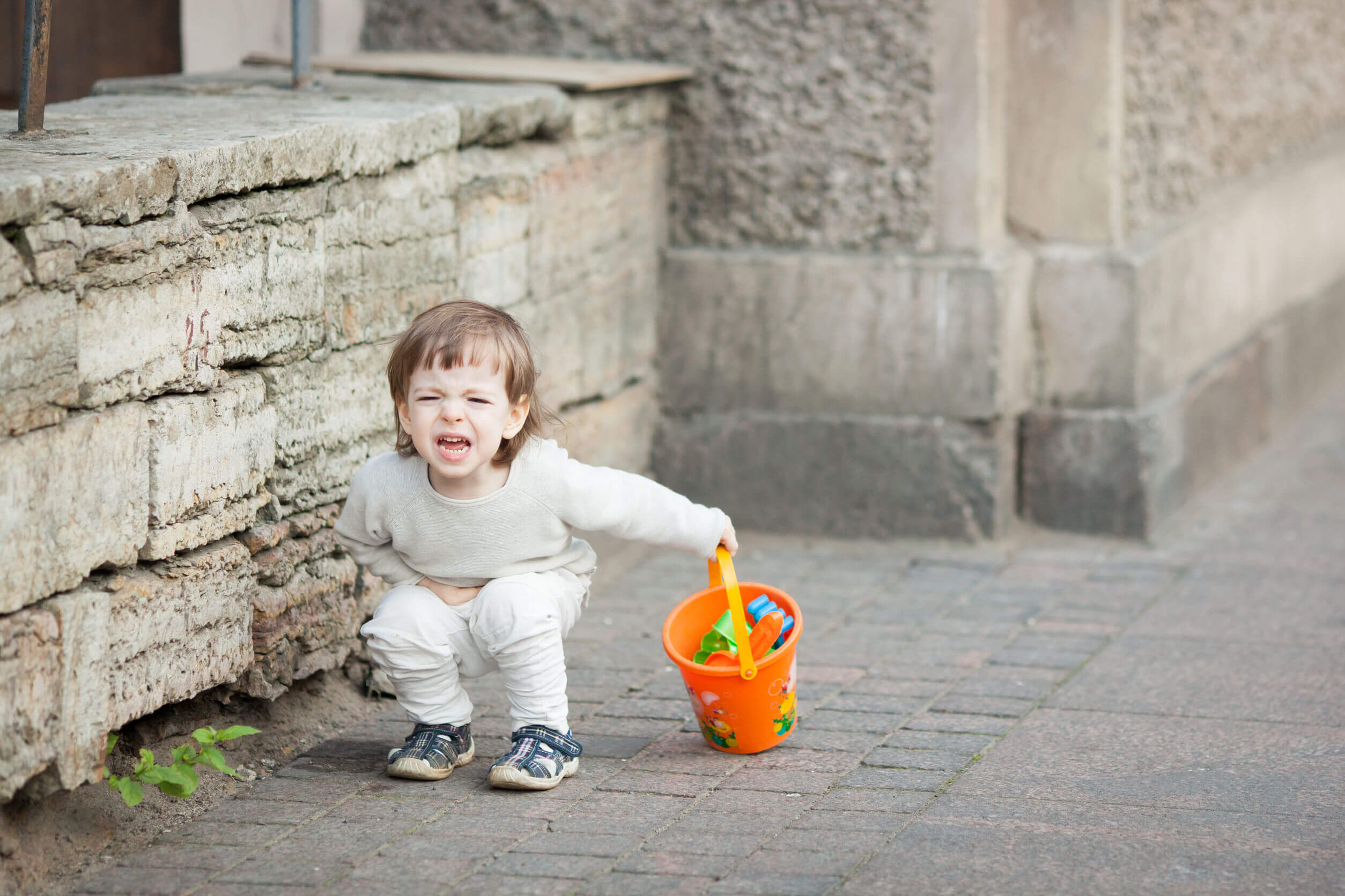 Niño teniendo una rabieta en la calle.