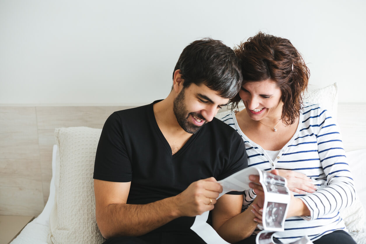 Parents looking at the ultrasound images of their baby.