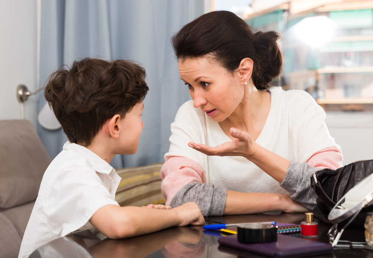 Madre hablando con su hijo sobre la superación personal.