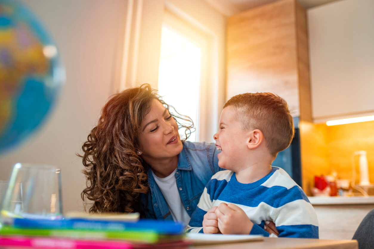A mother and child laughing together.
