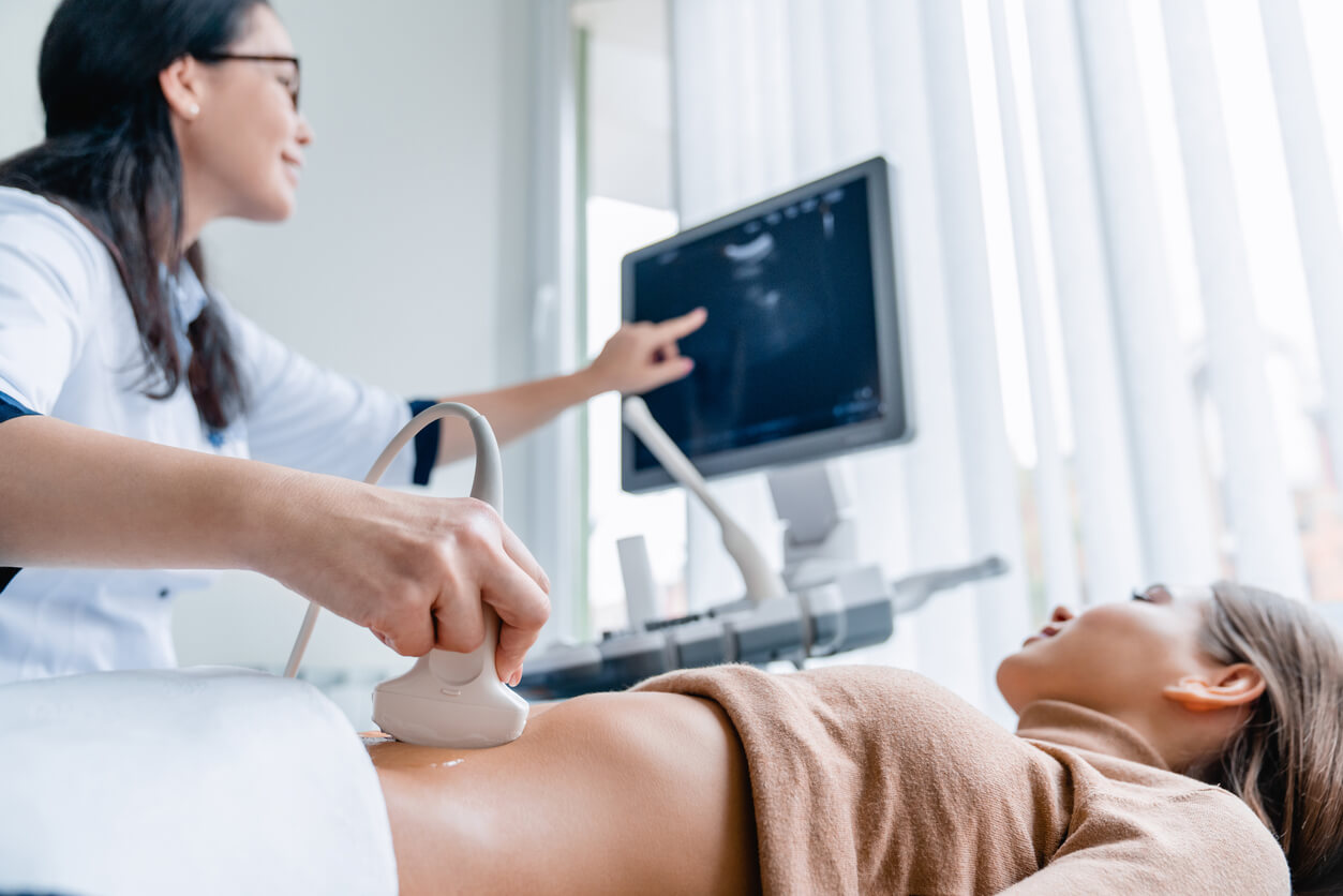 A woman getting an abdominal ultrasound.