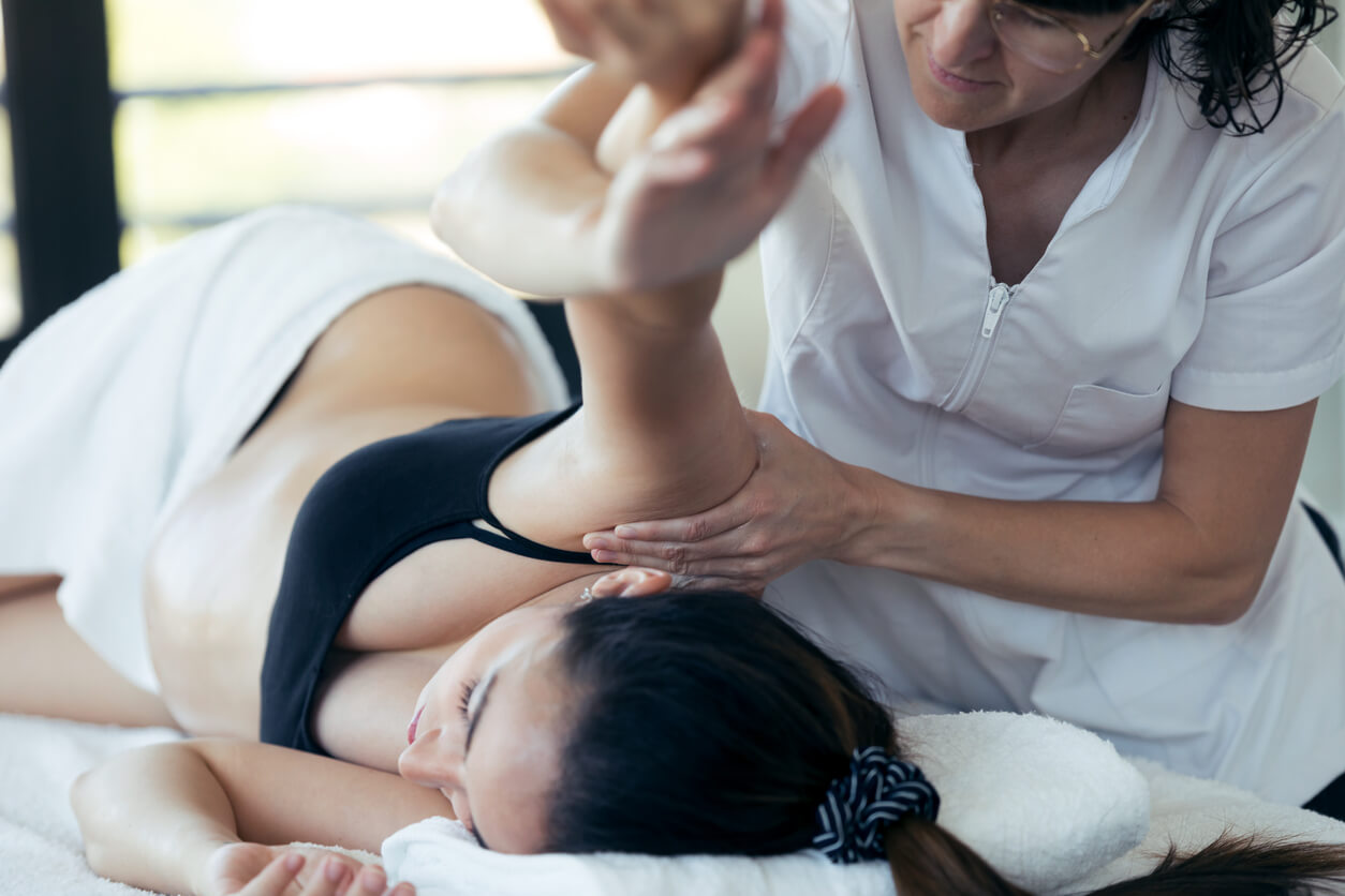 A pregnant woman receiving a massage.