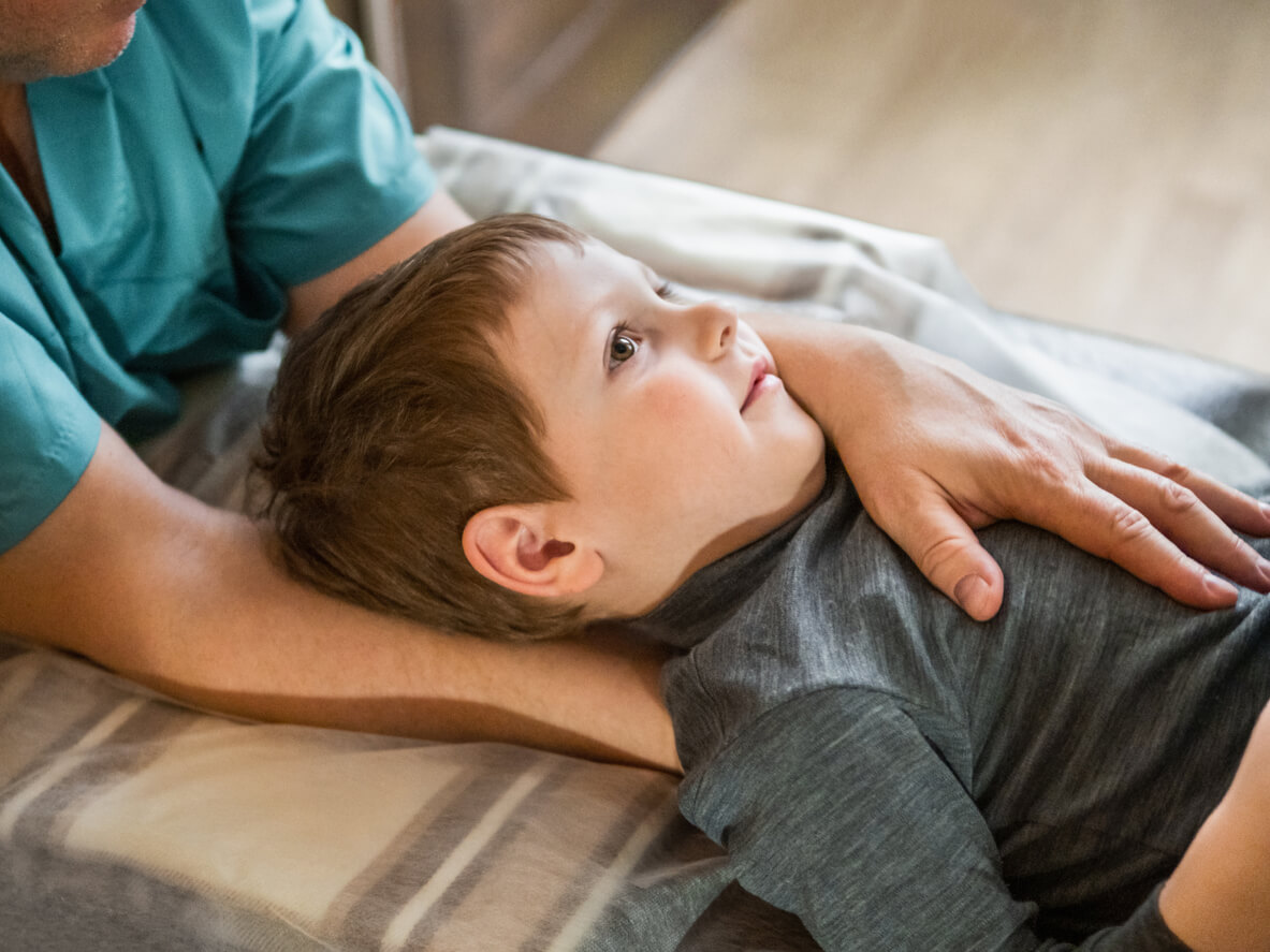 Niño en fisioterapia infantil con dolor de cuello.