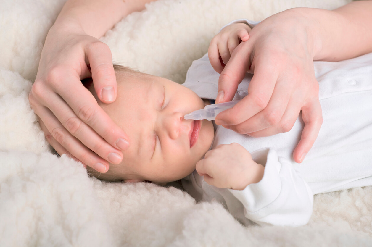 neonato mano adulto seno applica gocce nasali pulizia salina fisiologica secrezioni respiratorie muco