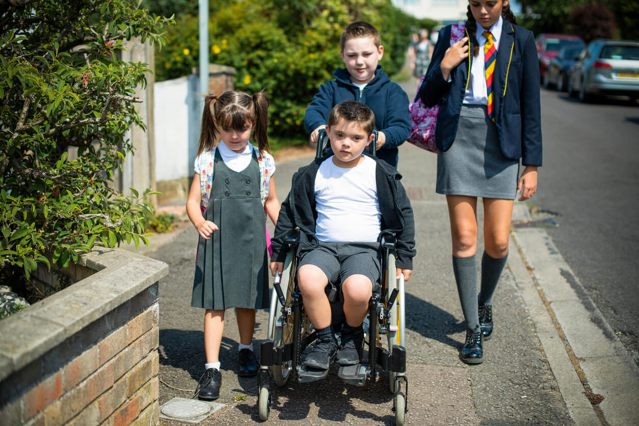 garçons filles frères sœurs accompagner besoins éducatifs particuliers handicap route école fauteuil roulant rue voie publique intégration