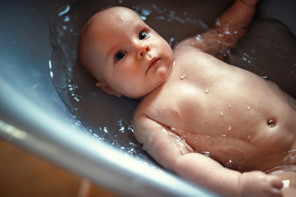 A newborn taking a bath.