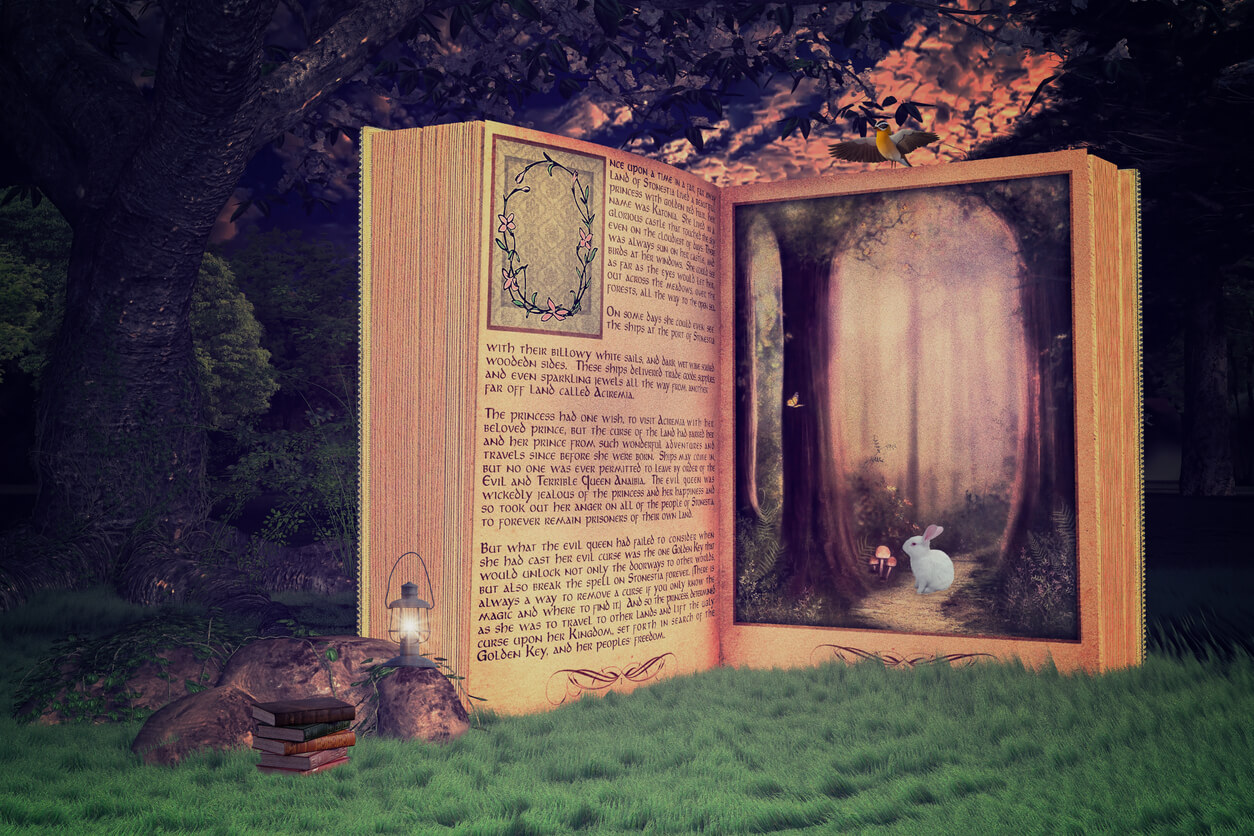A giant fantasy book sitting open in a forest.