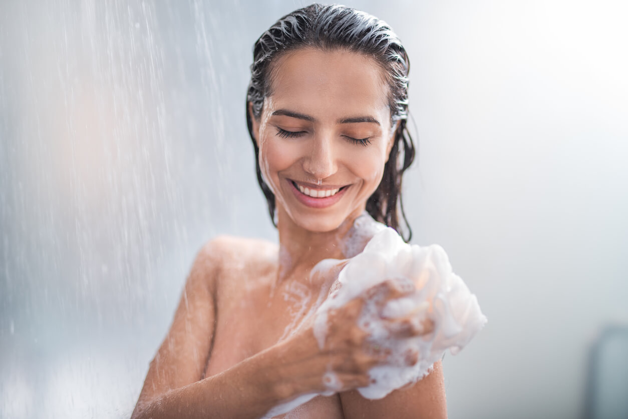 A woman soaping up in the shower.